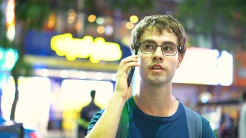 2 Clips of Young Man Taking a Call and Texting at Night On Smartphone Stock Footage 93439579