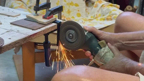 2 Close up of worker cutting metal piece with angle grinder tool in workshop Stock Footage 343421984
