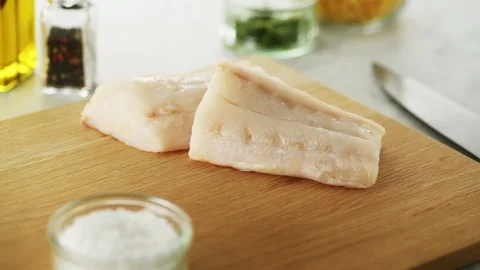 2 Cod fillets on a wooden board. Slight camera slide Stock Footage 92147521