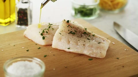 2 Cod fillets on a wooden board. Slight camera slide Stock Footage 92147730