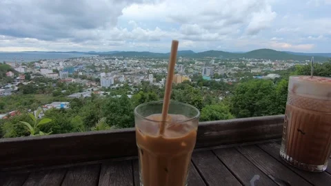 2 coffee glasses with a good view on city and sea with cloudy weather Stock Footage 155391470