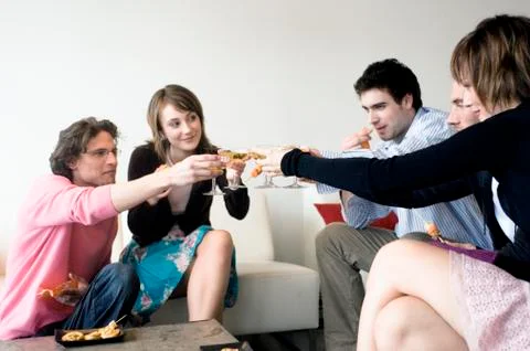 2 couples and a man clinking glasses of champagne Stock Photos