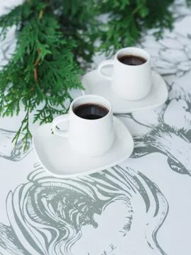 2 cups of coffee on the table, thuja twigs Stock Photos