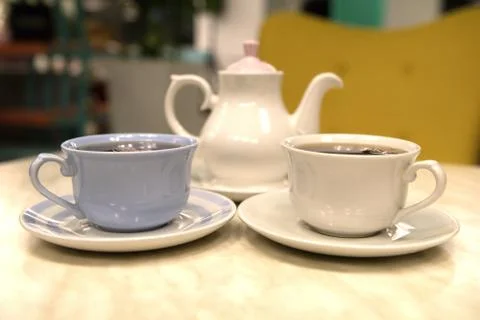 2 cups of tea and a kettle in the cafe Stock Photos