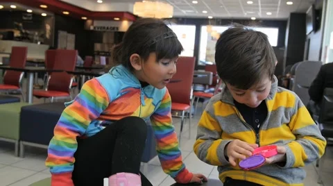 2 CUTE SIBLINGS PLAY IN RESTAURANT. Stock-Footage 63319621