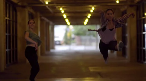 2 Dancers Leap Continuously Toward Camera Through A Tunnel In City (Slow Motion) Stock Footage 53457795