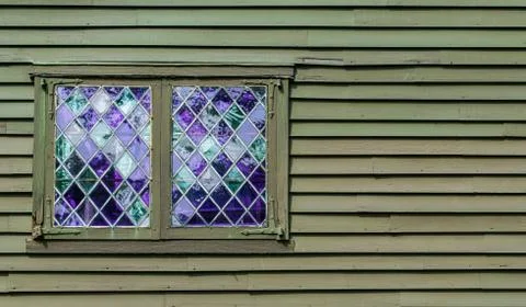 2 diamond pane windows in the wall of a colonial building with copy space Stock Photos