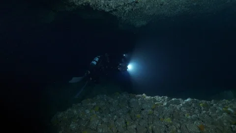 2 diver enter in the cave at the seabed, Ustica, Mediterranean sea Stock Footage 126915986
