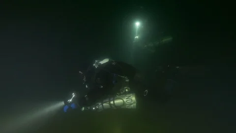  2 divers illuminate the bottom of the lake, Trevignano lake, Italy Stock Footage 104444925