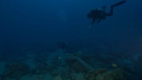 2 divers light up the anchor of the shipwreck Thistleghorm, Red Sea, Egypt Stock Footage 105431150