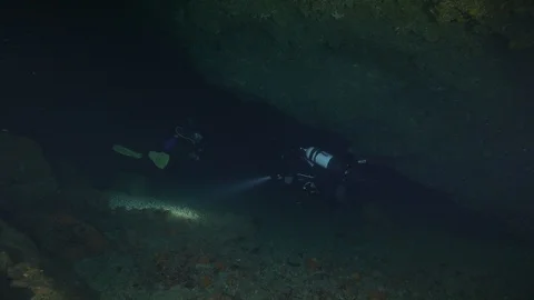 2 divers travel through the underground cave on the seabed, Ustica,Mediterranean Stock Footage 125105041