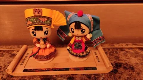 2 dolls placed on the table in a hotel room Stock Photos