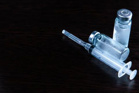 2 doses of Sars-Kov-2 coronavirus vaccine in transparent glass ampoules, cove Stock Photos