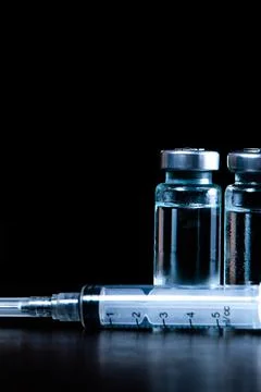 2 doses of Sars-Kov-2 coronavirus vaccine in transparent glass ampoules, cove Stock Photos