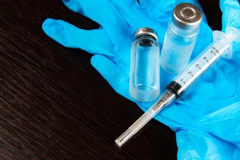 2 doses of Sars-Kov-2 coronavirus vaccine in transparent glass ampoules, cove Stock Photos