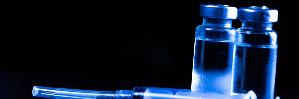 2 doses of Sars-Kov-2 coronavirus vaccine in transparent glass ampoules, cove Stock Photos