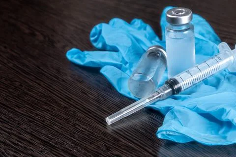 2 doses of Sars-Kov-2 coronavirus vaccine in transparent glass ampoules, cove Stock Photos