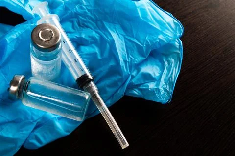 2 doses of Sars-Kov-2 coronavirus vaccine in transparent glass ampoules, cove Stock Photos