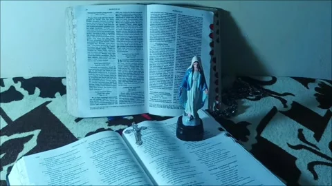 2 Easter Bibles with Stone Rosaries and Statues of the Virgin Mary Stock Footage 330516459
