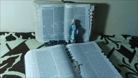 2 Easter Bibles with Stone Rosaries and Statues of the Virgin Mary Stock Footage 330516461