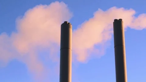 2 factory chimneys pipe with smoke at blue sky background Stock Footage 73483770