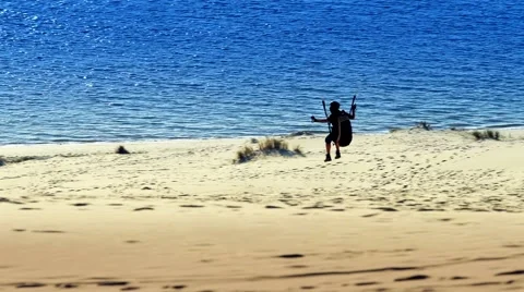 2 Files. Paraglider Soaring Over a dune during sunset. Stock Footage 58728696