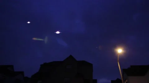 2 Flying Saucer UFO Crafts at night over residential neighborhood Stock Footage