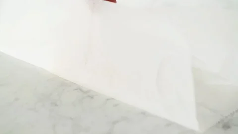 2 fresh cod fillets opened from grease-proof paper on marble. Stock Footage 92145399