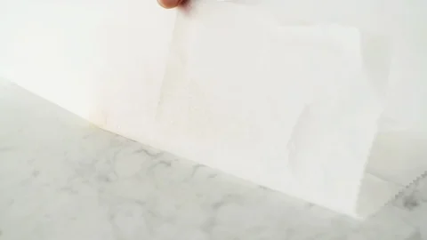 2 fresh cod fillets opened from grease-proof paper on marble. Stock Footage 92145521