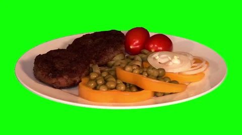 2 fried beef chops with raw vegetables on plate Stockbeeldmateriaal 47544868