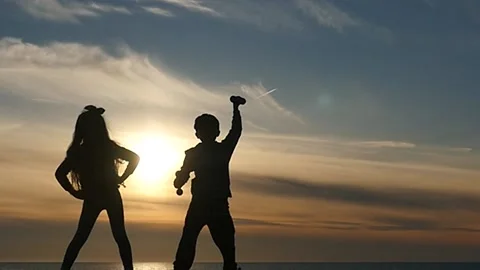 2 funny small kids making physical exercises silhouettes Stock Footage 197565273