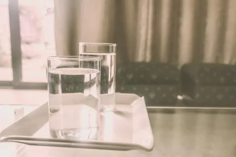2 Glasses of Drinking Water on table. Morning Sunlight coming from window. Tw 스톡 사진
