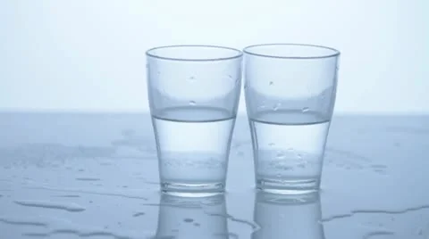 2 glasses on wet background Stock Footage 11899117