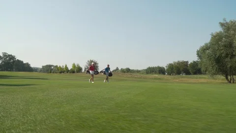 2 golf player walking at a golf course 스톡 동영상 96011947