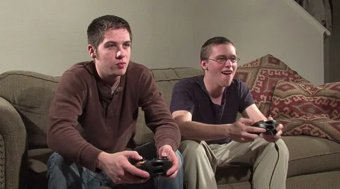 2 guys playing video games. On a couch. Stock Footage 49862848