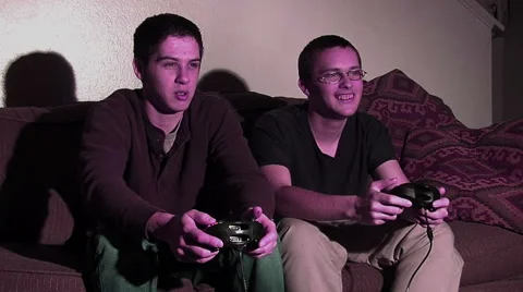 2 guys playing video games. Lit by TV screen. Stock Footage 49862861