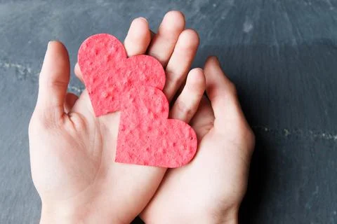 2 hearts in hand Stock Photos