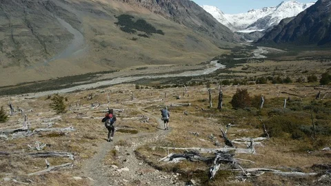 2 Hikers walking down the valley at Huemul loop Stock Footage 89687285