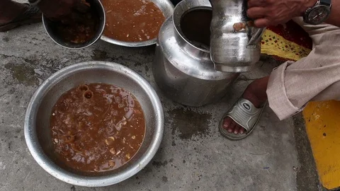 2-indian-man-makes-tamarind-pulp-in-large-vessel Stock Footage 93378518