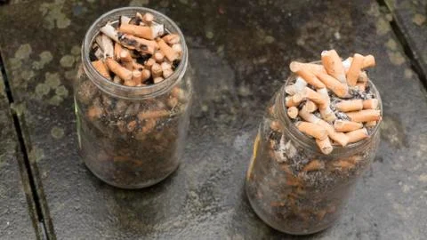2 jars full of cigarettes. Antismoking concept. Stock Photos