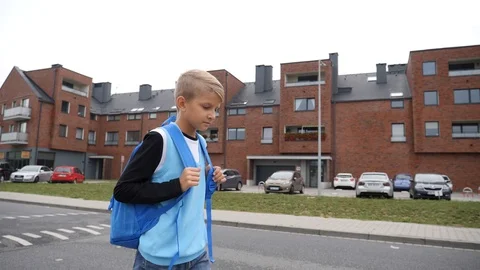 2 Kid boy goint to school walking through city residential area Stock Footage 94613270