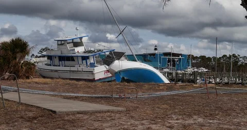 2 large beached boats from storm surge in Port St. Joe Marina Hurricane Michael Stock Footage 98186377