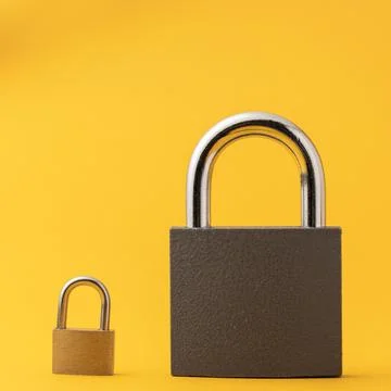 2 locks on a yellow background. Stock Photos
