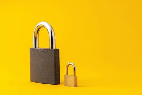 2 locks on a yellow background. Stock Photos