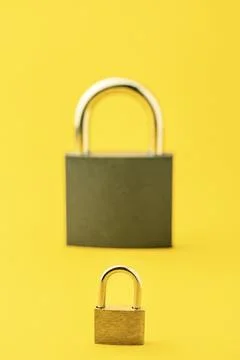 2 locks on a yellow background. Stock Photos
