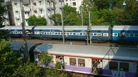 2 Long Indian Passenger express &amp; Mumbai local Train moving in speed India Stock Footage 153167335