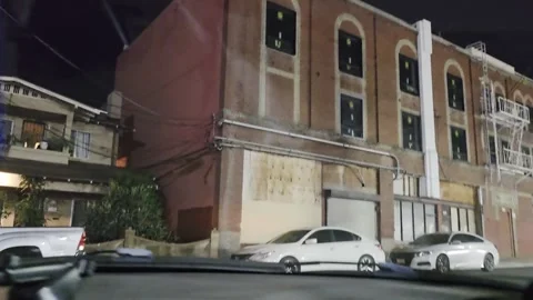2 May 2024 Los Angeles, California - Driving Apartment Building Night Stock Footage 321704588