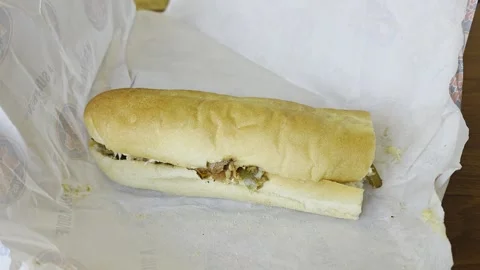 2 May 2024 Miami, Florida - Eating Philly Steak Sandwich Stock Footage 333996843