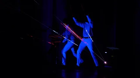 2 men dance and play electronic drums during the laser show Stock Footage 71338155