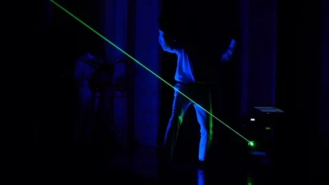 2 men dance and play electronic drums during the laser show Stock Footage 71339924